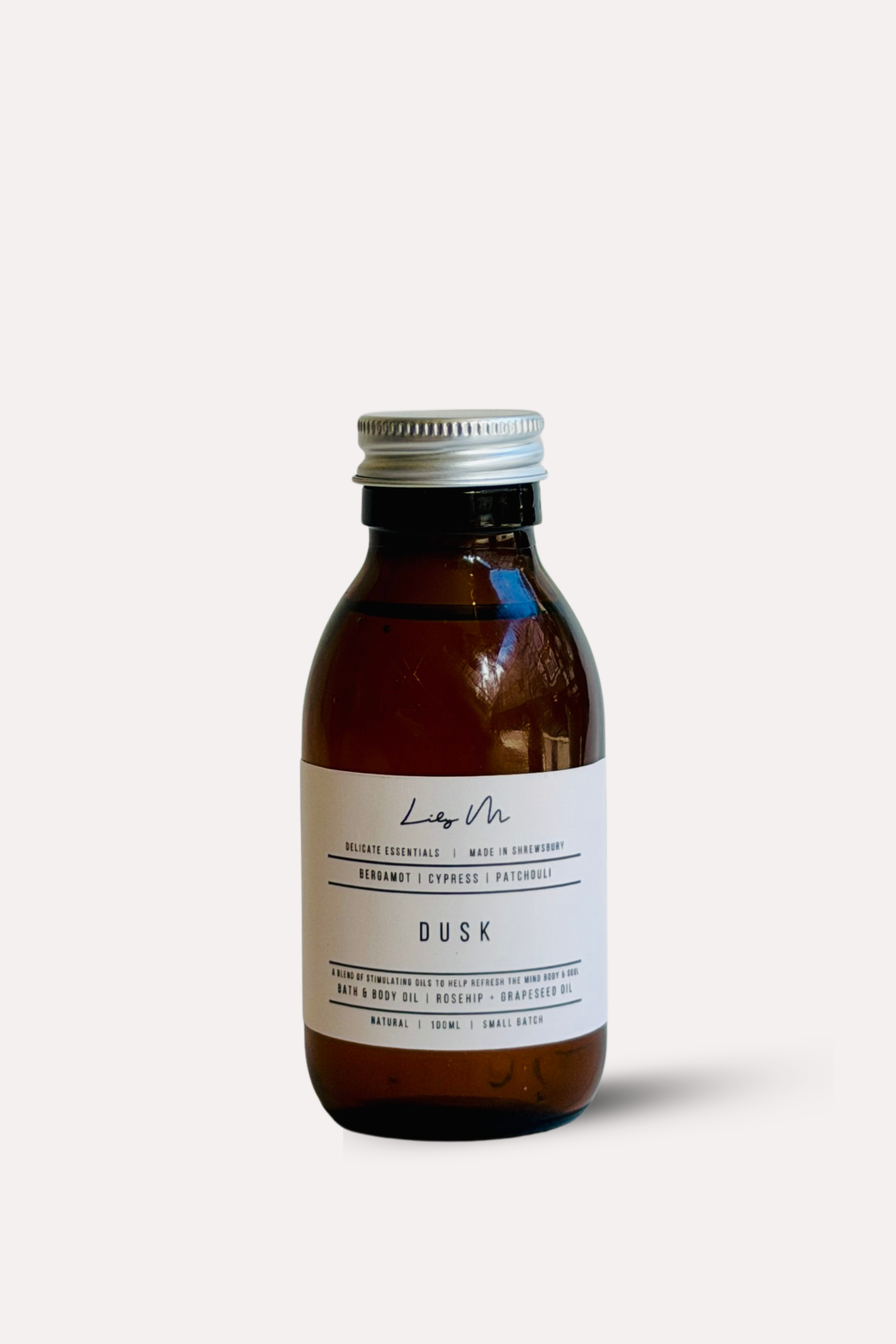 Brown bottle with silver cap and label on a white background