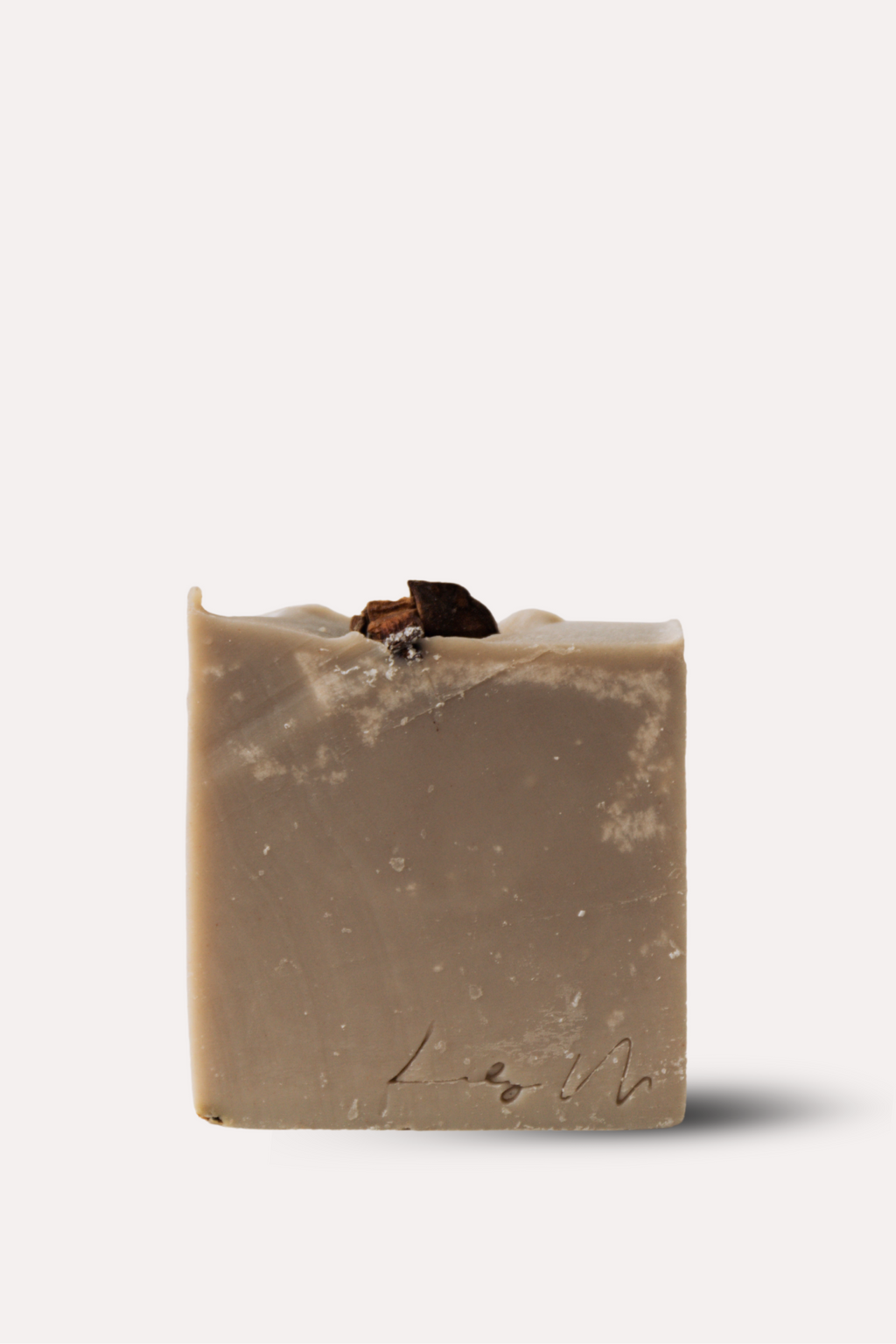 Bar of soap with a natural, slightly rough texture on a white background
