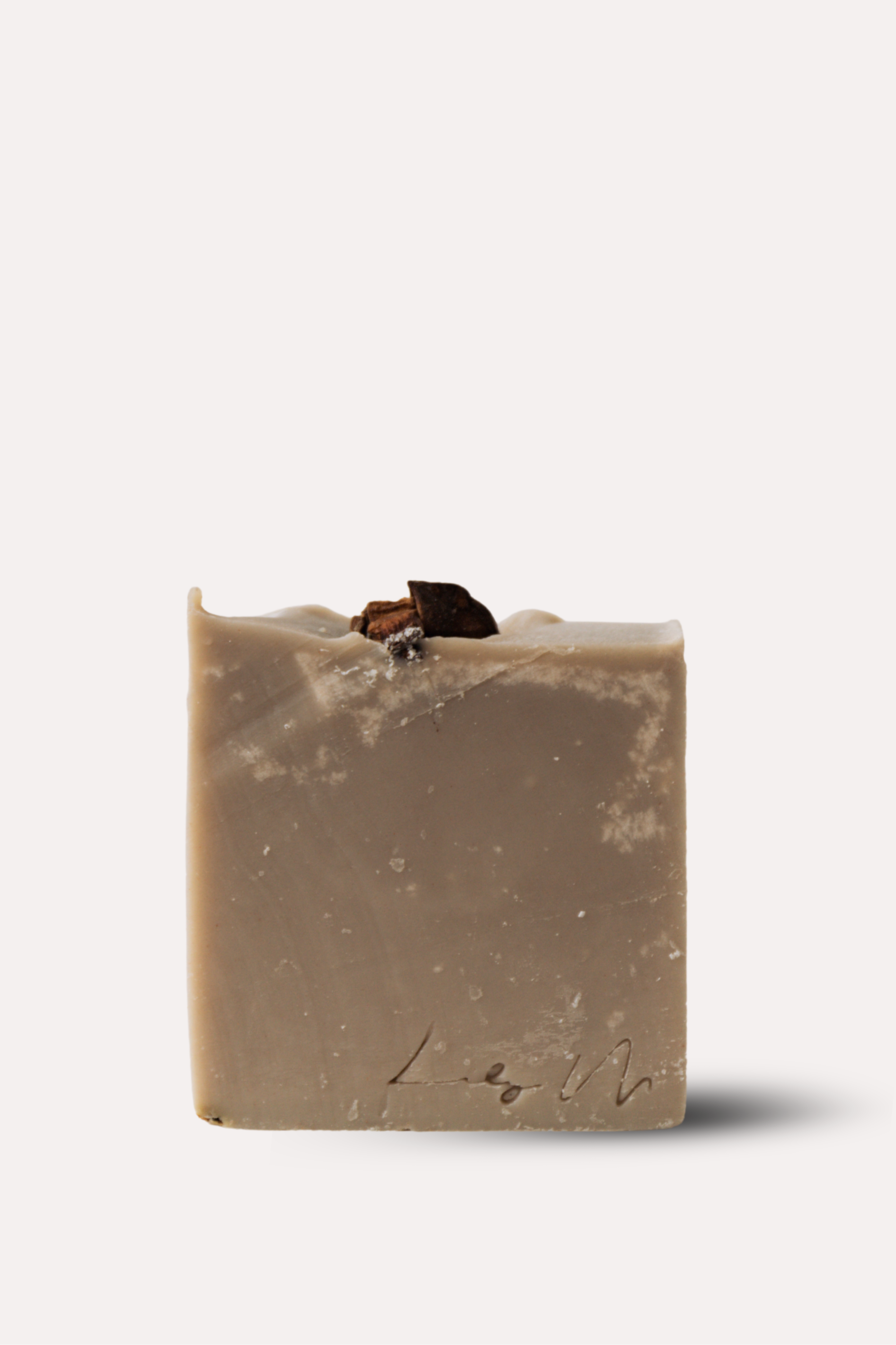 Bar of soap with a natural, slightly rough texture on a white background