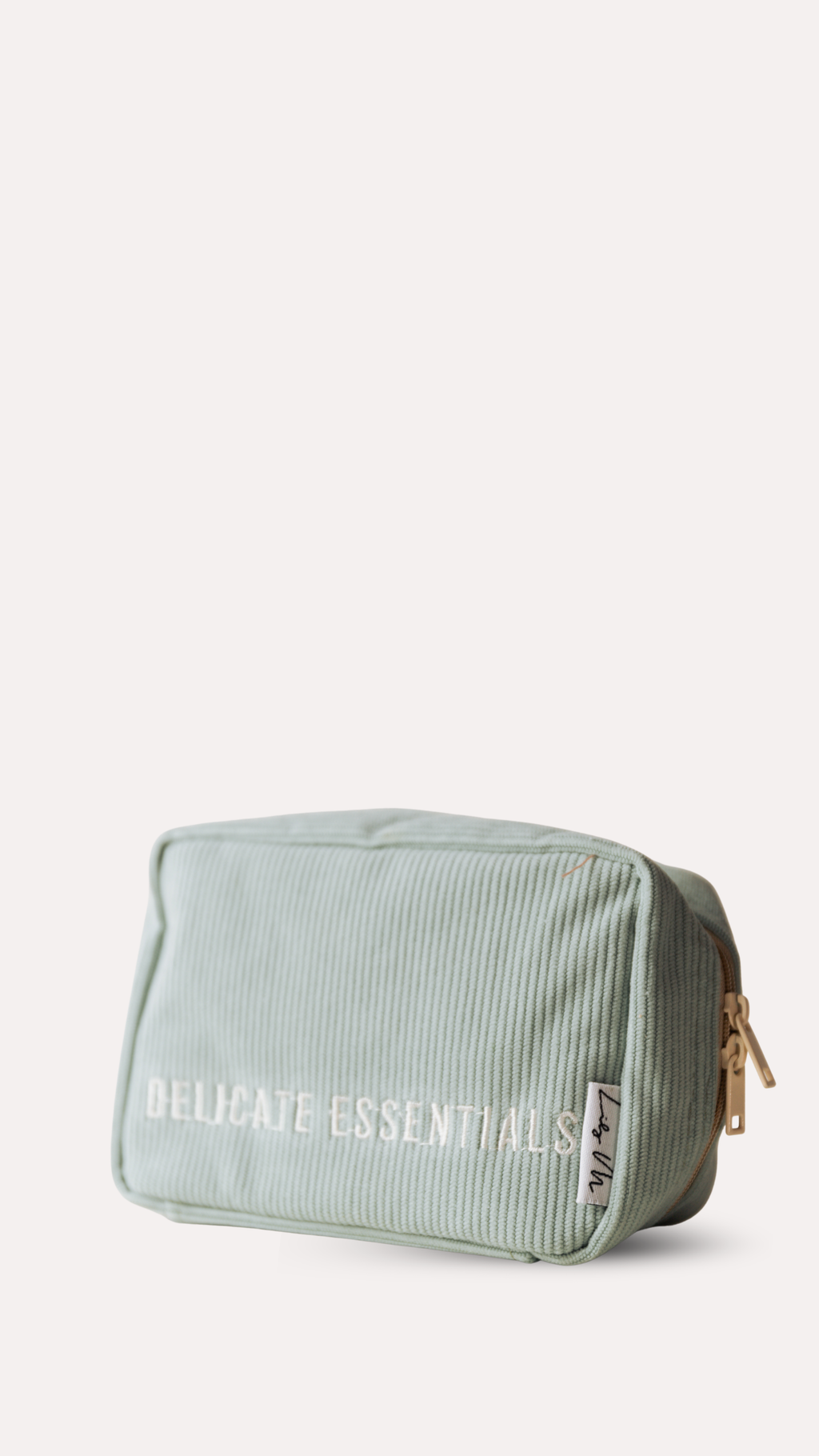 Light green toiletry bag with the signature Lily M 'Delicate Essentials' text