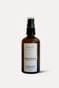 Brown spray bottle labeled 'Citrus Grove' on a white background