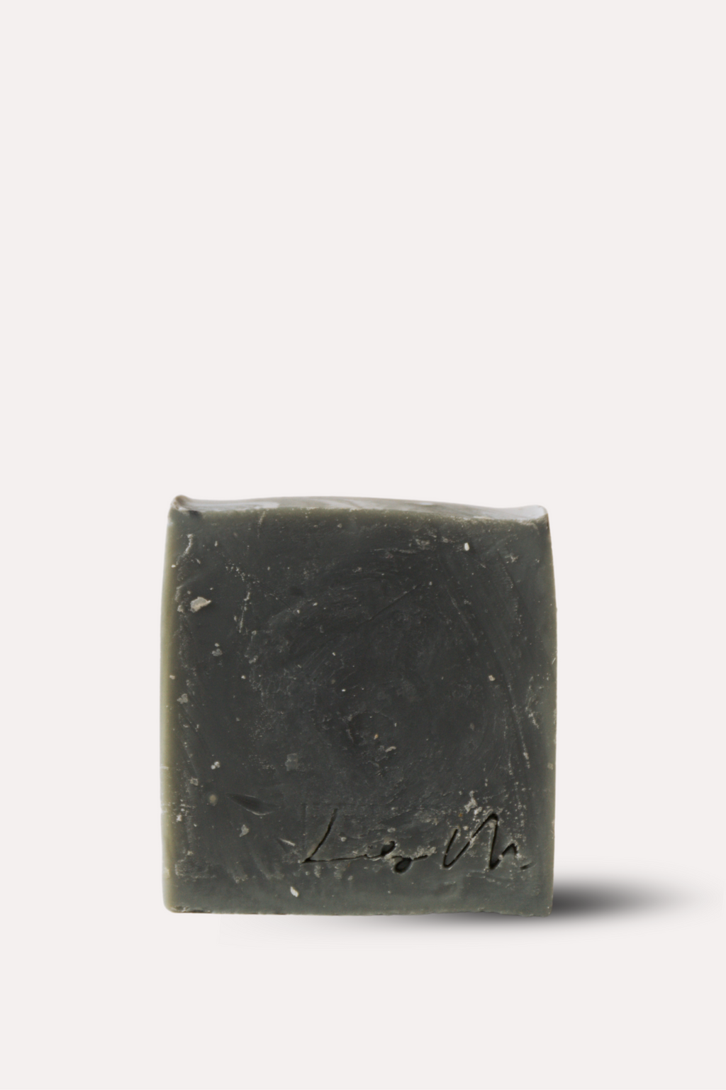 Bar of dark soap on a white background