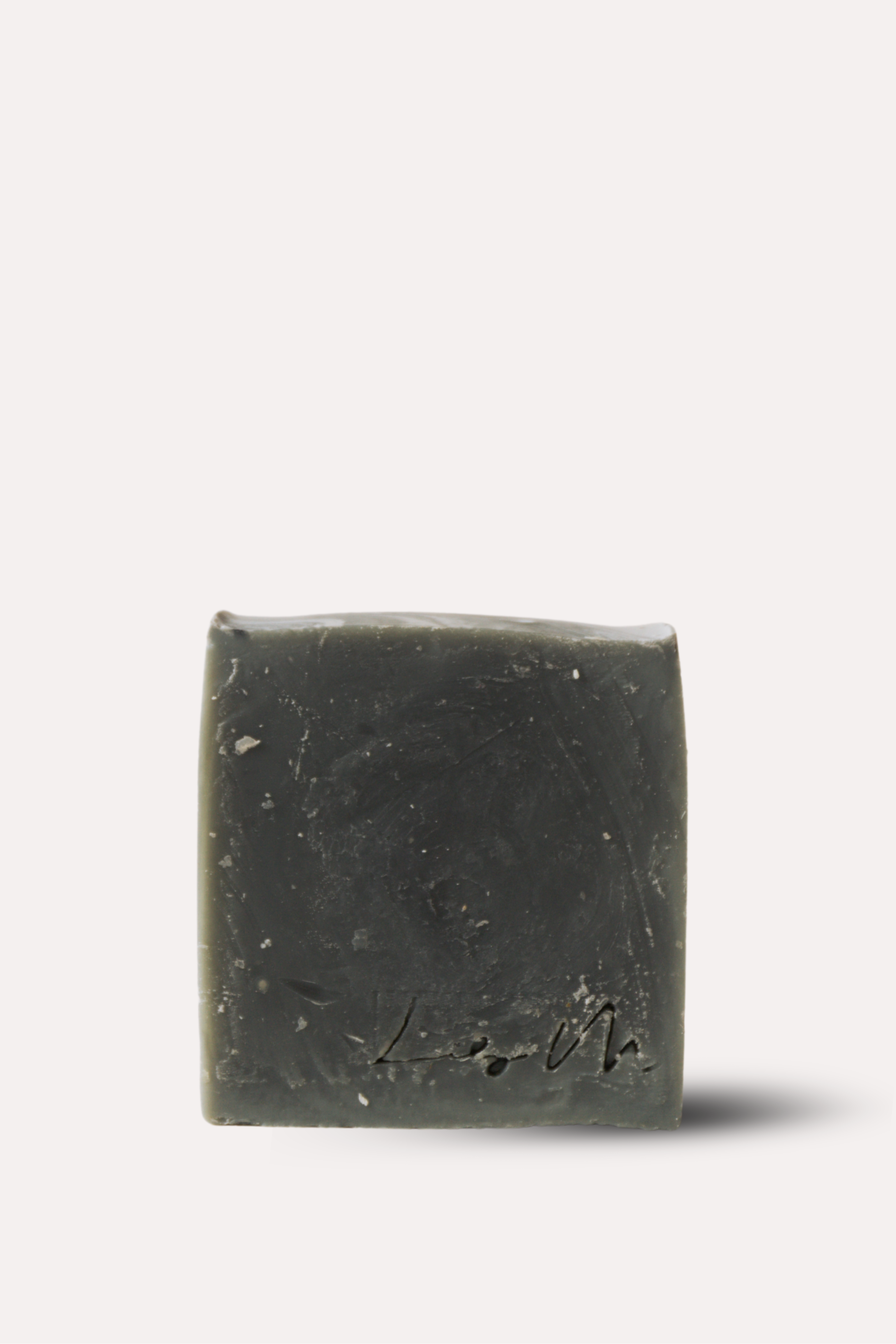 Bar of dark soap on a white background