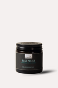 Jar of face polish with a black lid on a white background