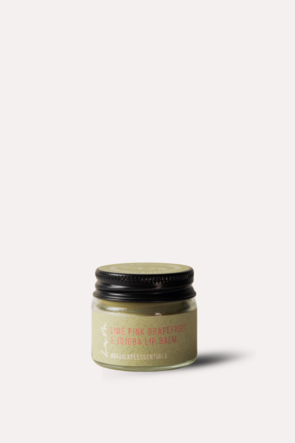 Small jar of cream with a black lid on a white background
