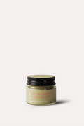 Small jar of cream with a black lid on a white background