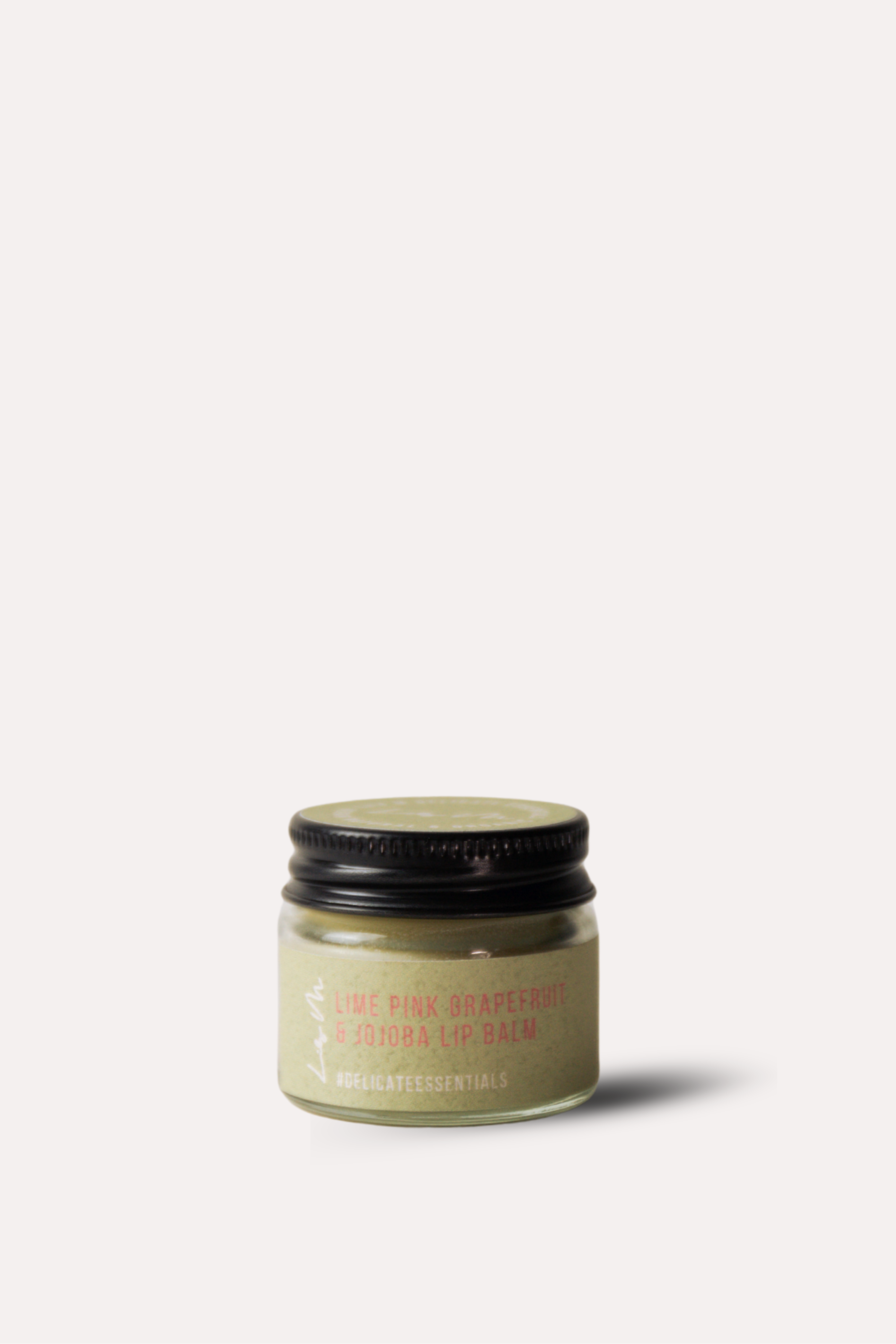 Small jar of cream with a black lid on a white background