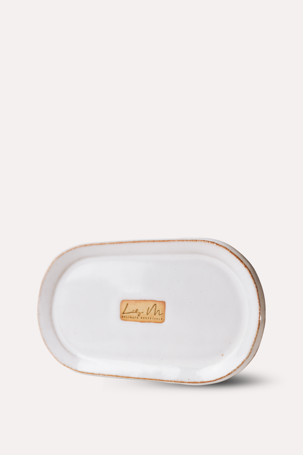 Rectangular ceramic tray with gold rim on a white background