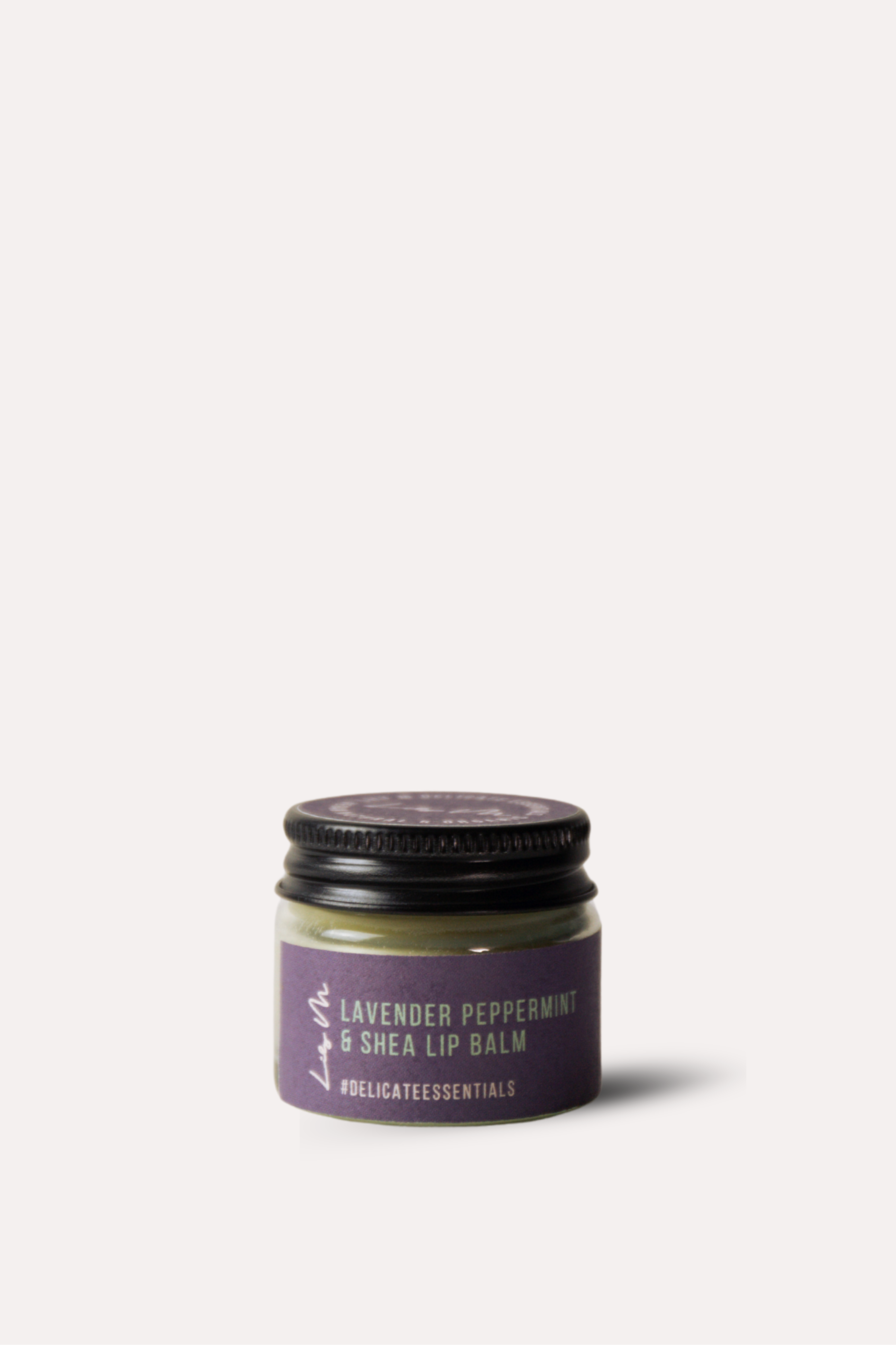 Jar of lavender peppermint shea lip balm on a white background