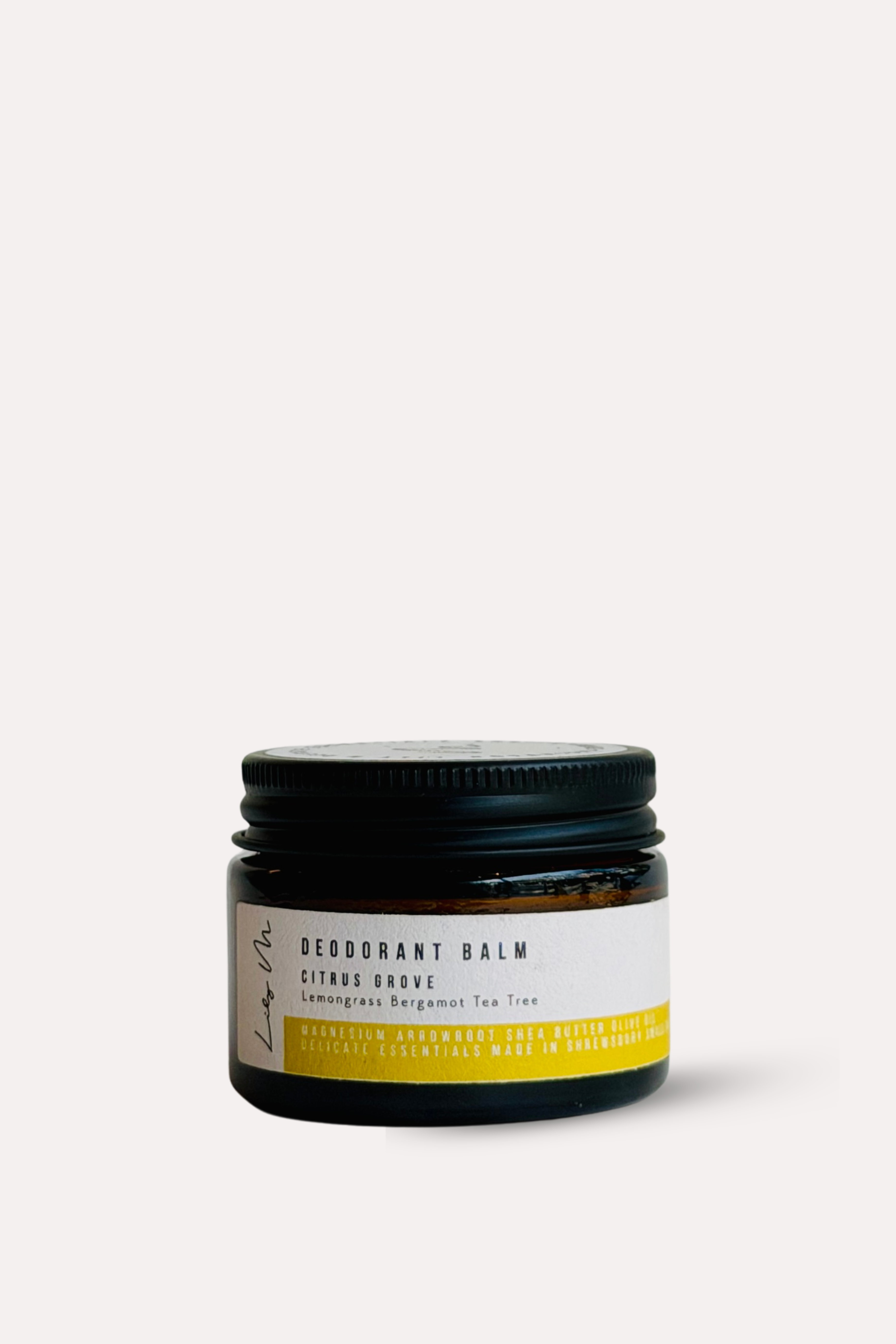 Jar of deodorant balm with a black lid on a white background
