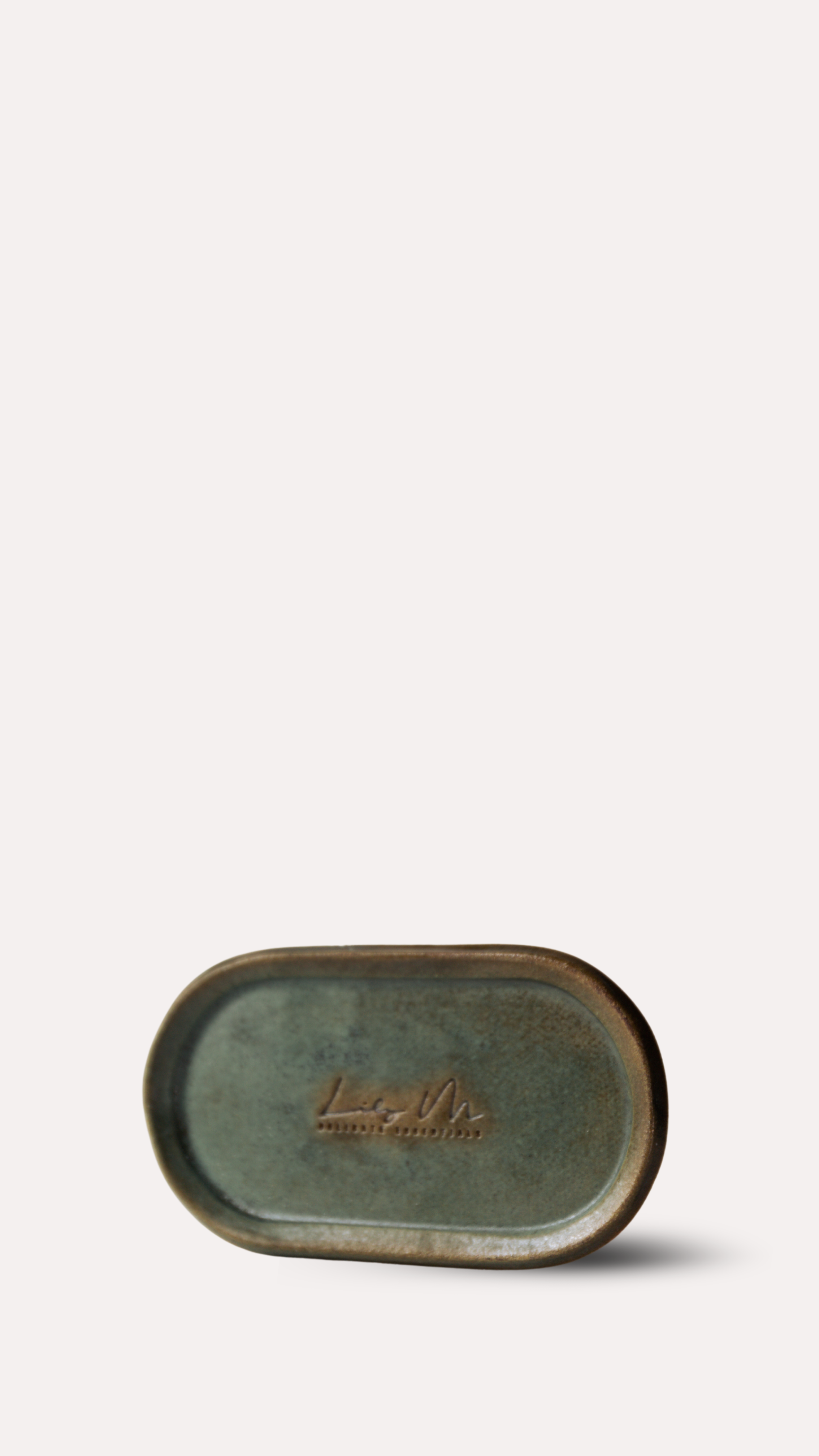 Green ceramic tray with Lily M branding on a white background