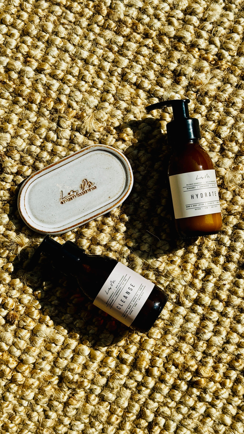 Two bottles and a mini bottle tray on a textured surface