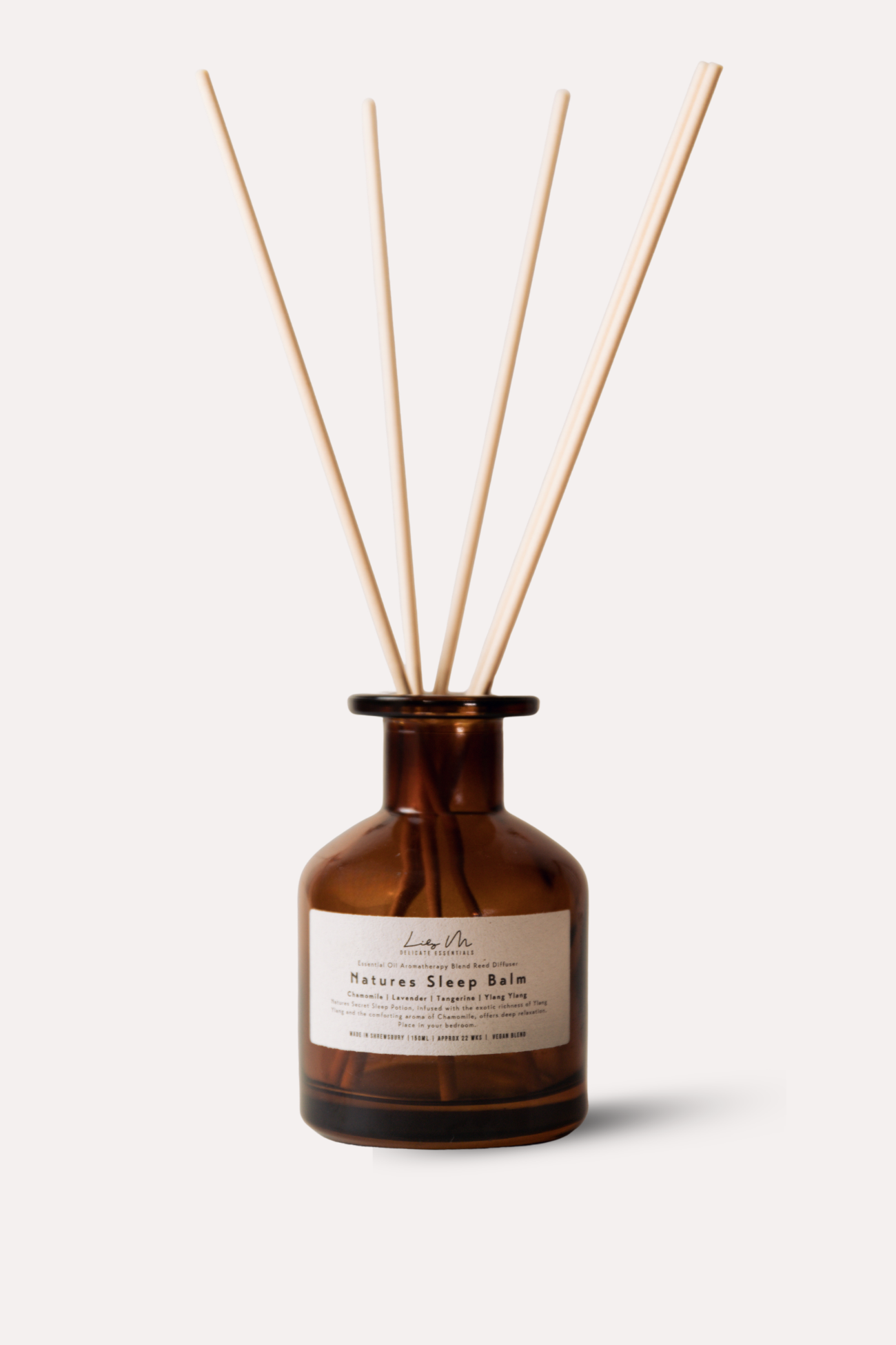 Brown diffuser bottle with wooden sticks on a white background