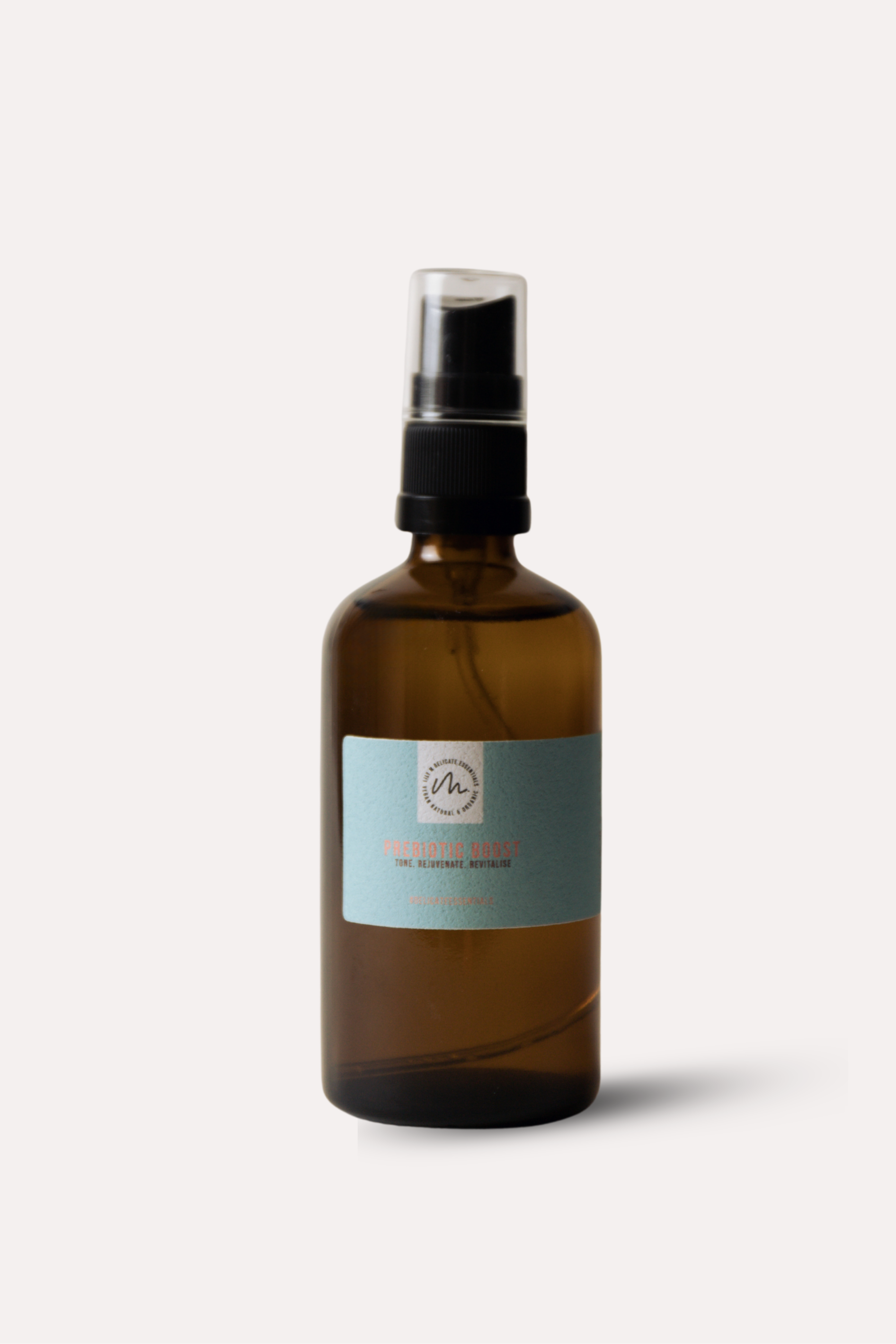 Brown spray bottle with a label on a light gray background