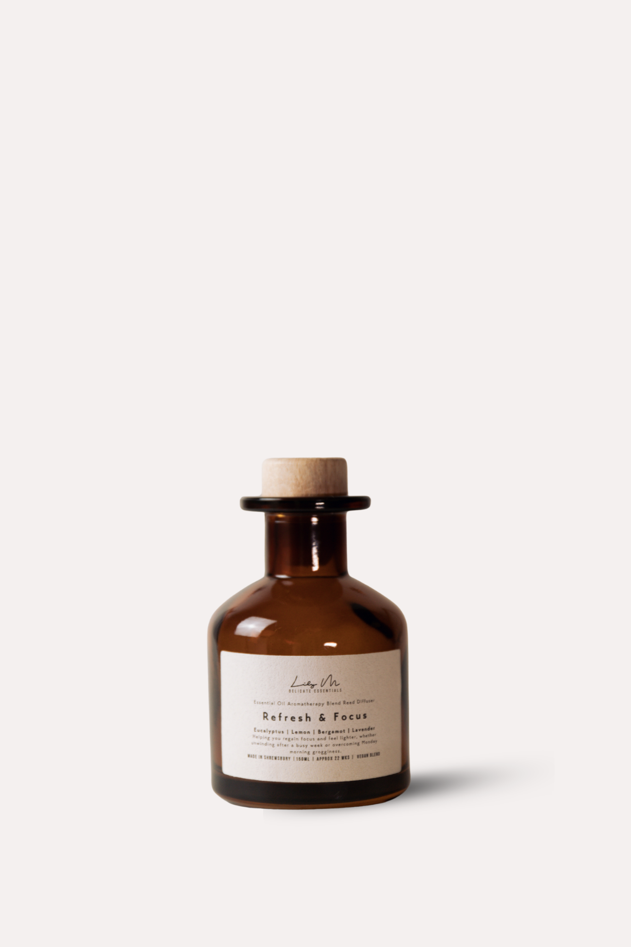 Brown bottle with cork stopper and label on a white background