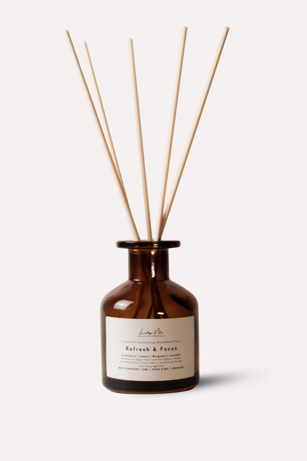 Brown glass diffuser bottle with wooden sticks on a white background
