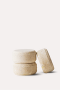 Three beige ceramic containers stacked on a white background - shower steamers