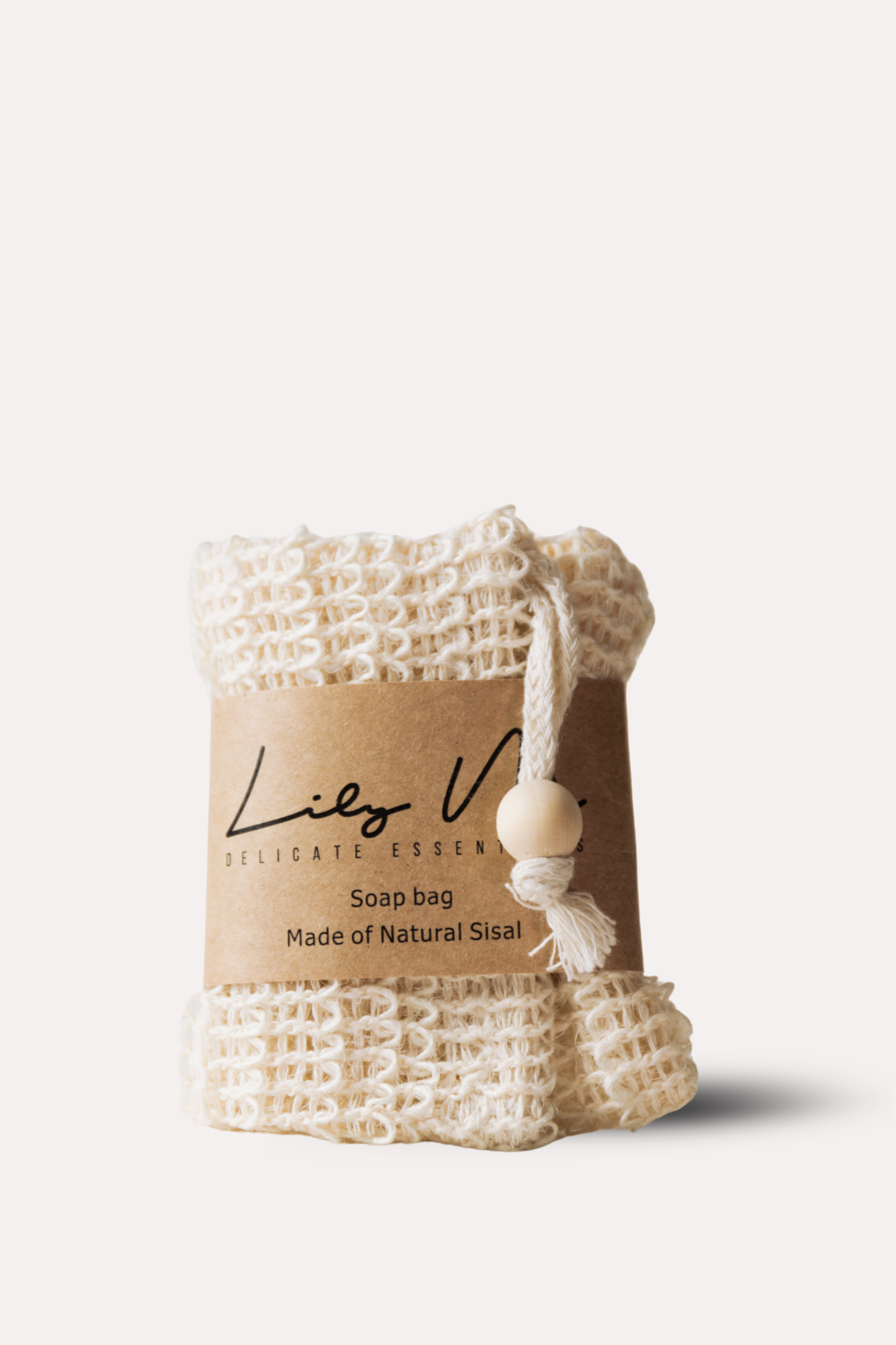 White woven soap bag with a label on a light beige background