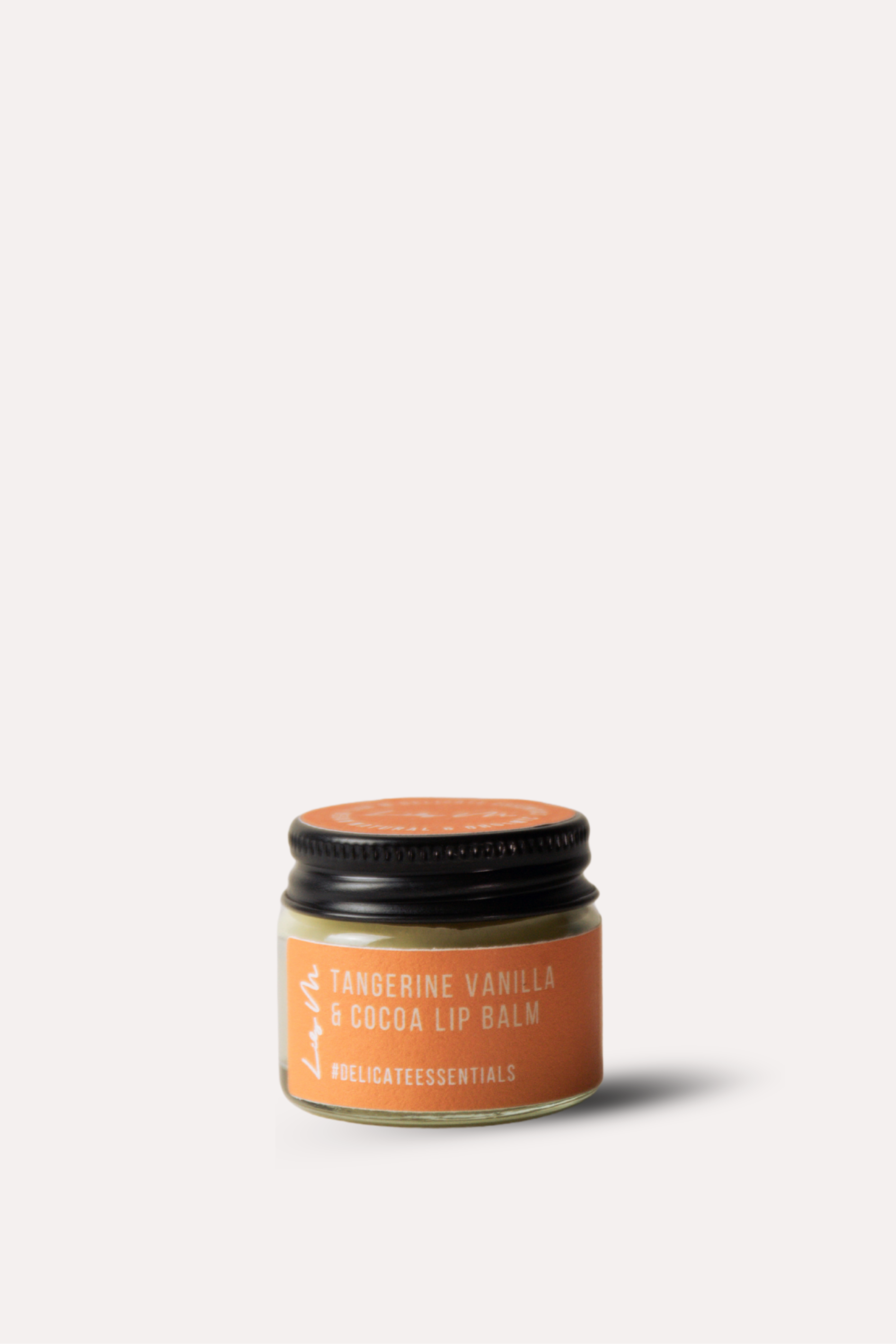 Jar of lip balm with a black lid on a white background