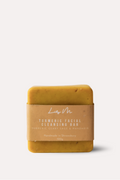 Yellow soap bar with a brown label on a white background