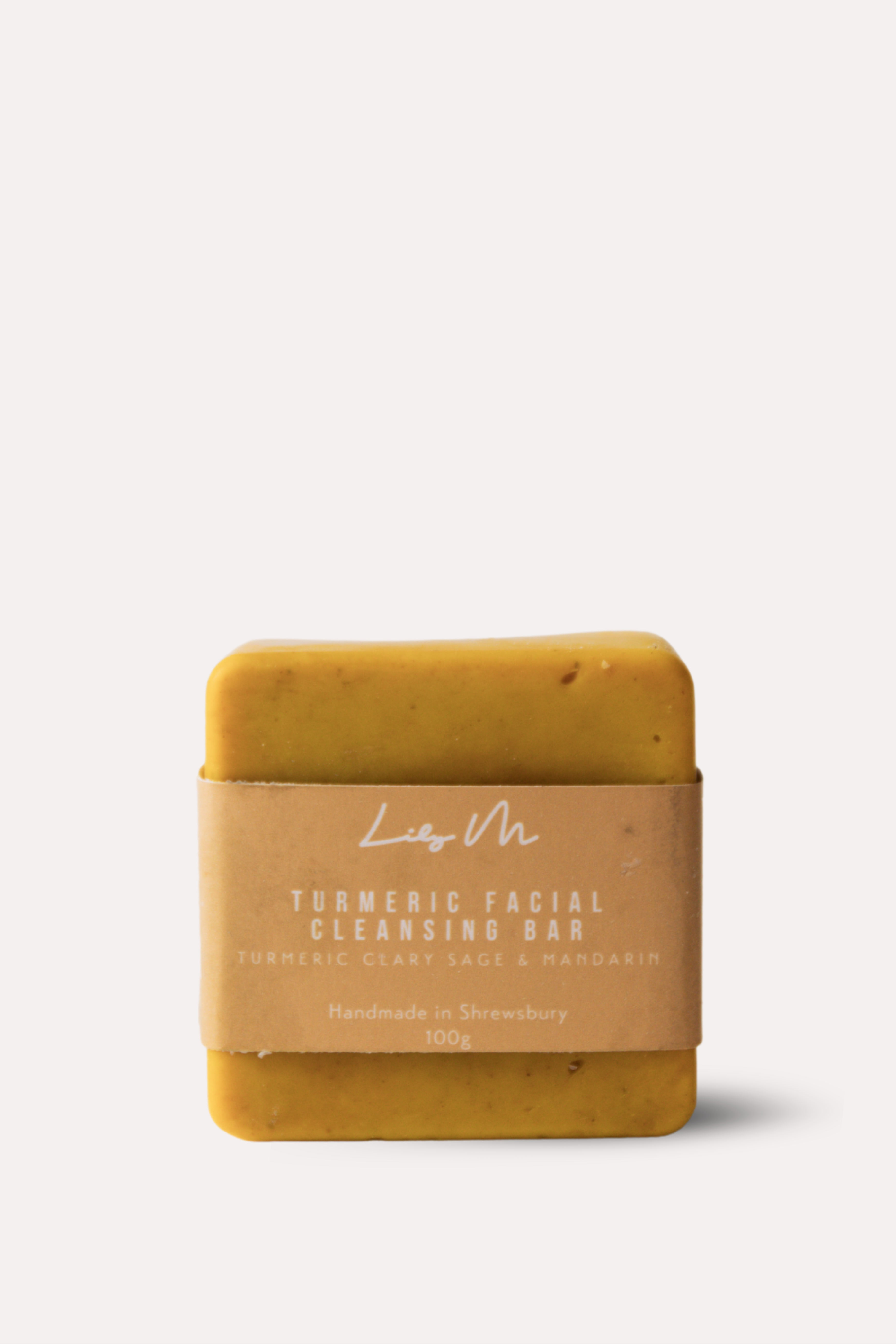 Yellow soap bar with a brown label on a white background
