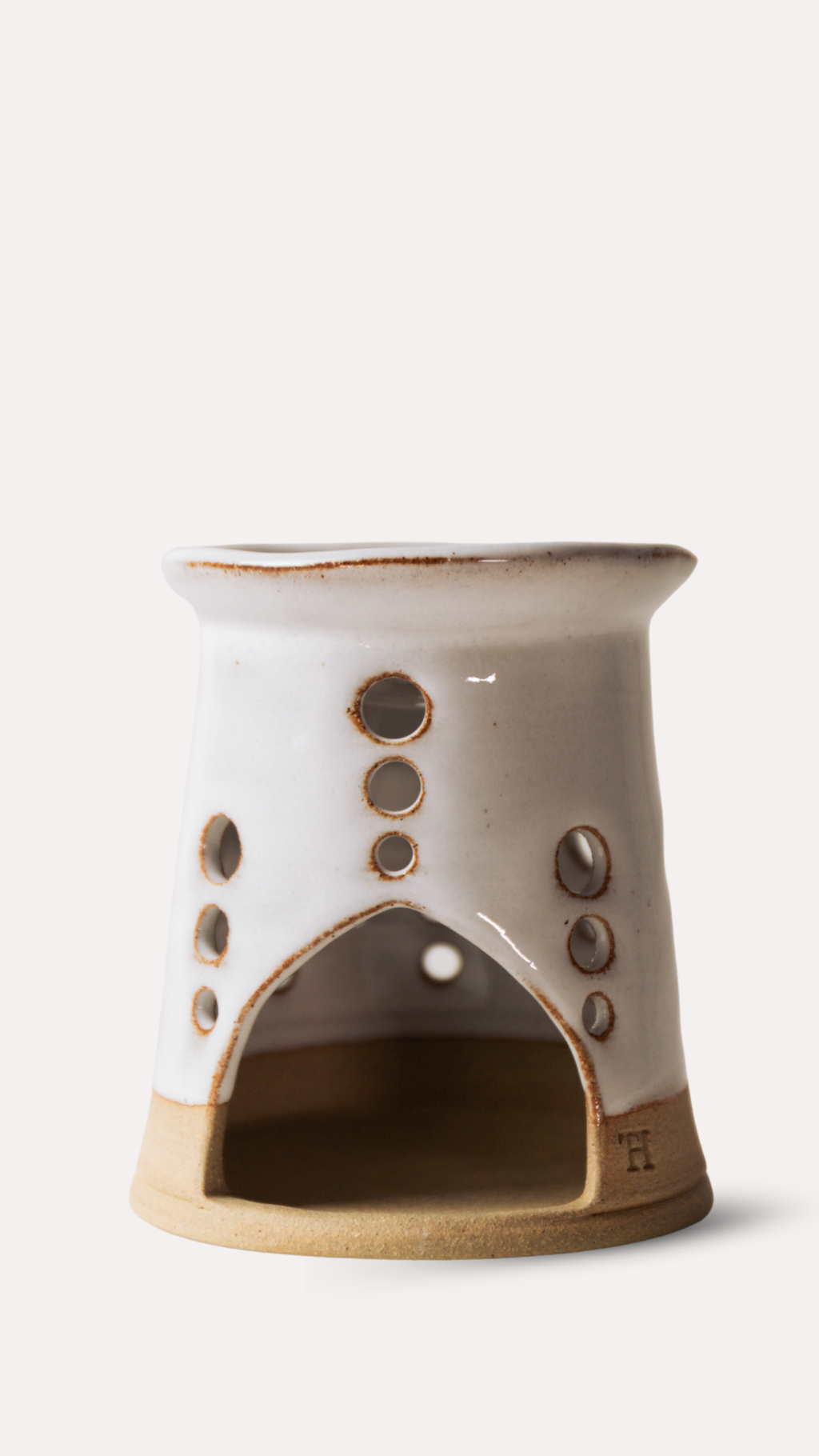 Ceramic oil or wax melt burner with a textured design on a white background