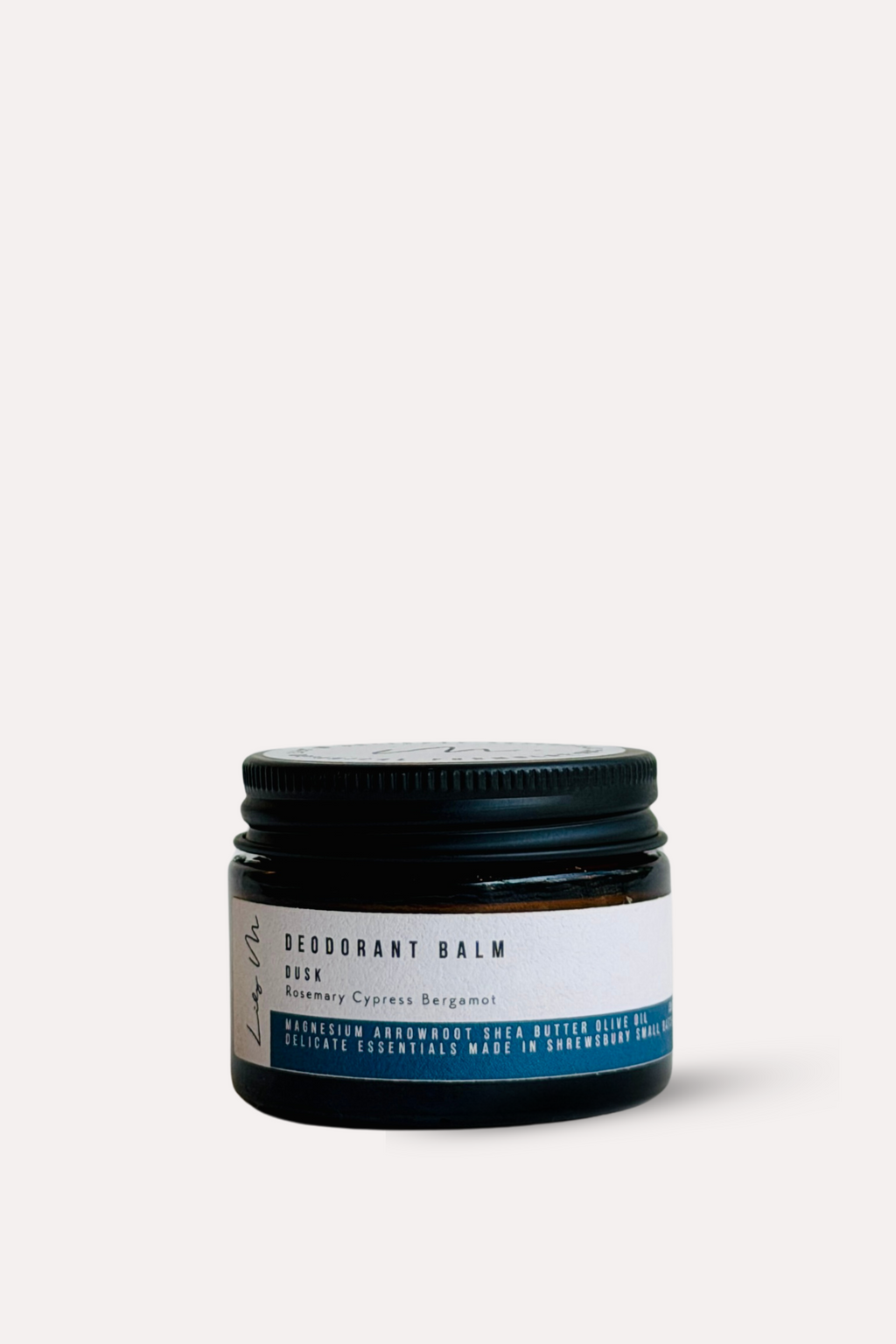 Jar of balm with a black lid on a white background
