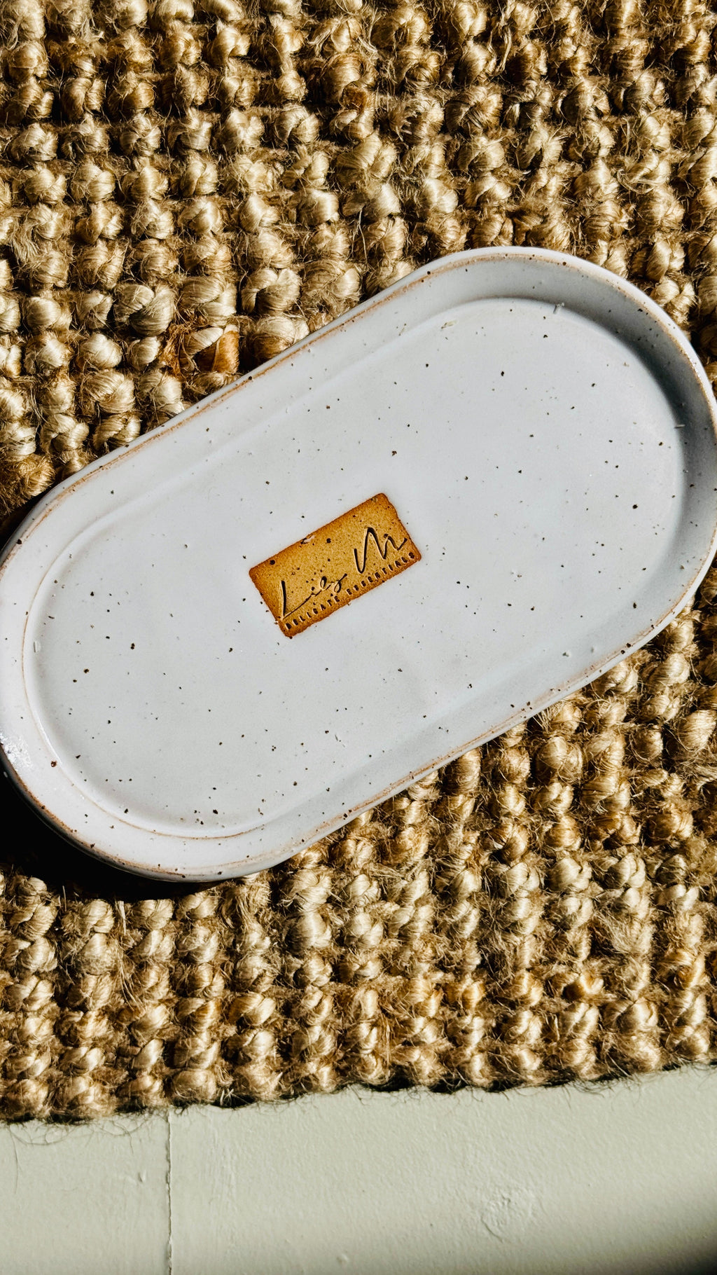 hand wash bottle tray on a hessian rug Lily M logo stamped in the the center of the tray unglazed, shows a brown rectangle around the logo