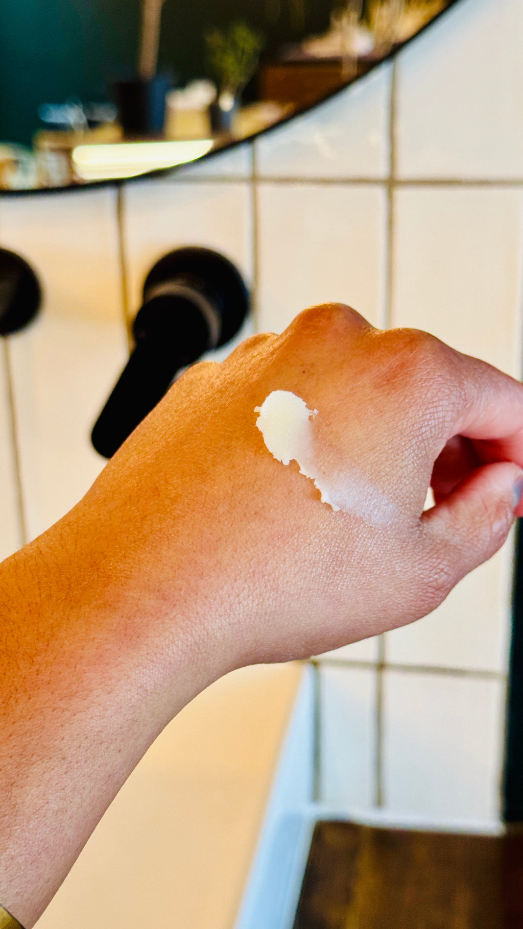 a scoop of the balm on a hand showing the texture