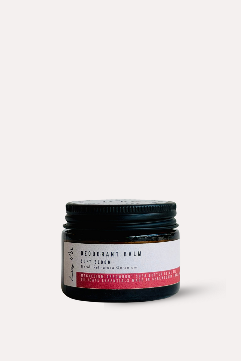 Jar of deodorant balm with a black lid on a white background